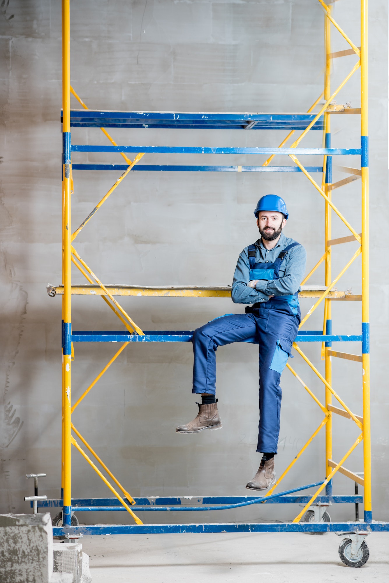 Builder on the scaffolding indoors